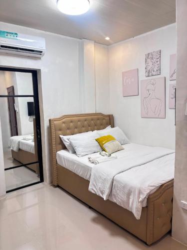 a bedroom with a bed and a mirror at Next House Passi City in Iprog