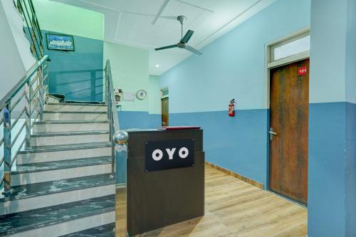 a hallway with a door and stairs in a building at Hotel O Urban Rooms in Neemrana
