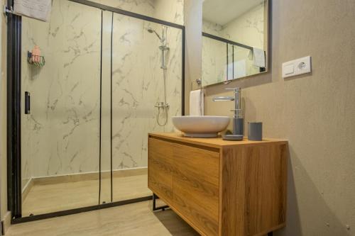 a bathroom with a sink and a shower at Ondo Beach & Suites in Bodrum City