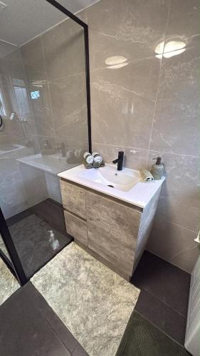 a bathroom with a sink and a shower at Family Friendly One Bedroom Studio in Brisbane