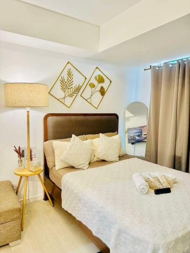 a bedroom with two beds and a lamp in it at Azure Urban Resort Residences St Tropez Tower Near SM Bicutan with Wave Pool in Manila