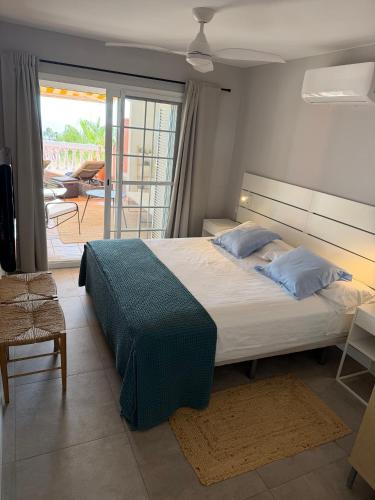 a bedroom with a large bed and a balcony at Playa del Duque-Amazing views 2 bedroom in Adeje