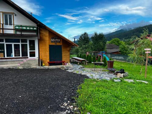 a house with a gravel driveway in front of it at Casa Adela LaculRosu Bicaz in Neagra