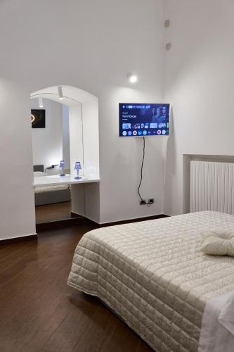 a bedroom with a bed and a bathroom with a sink at Tiare' in Trani