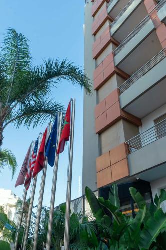 a row of flags in front of a building at Flamant Rose Appart Hotel in Tangier