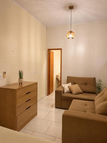 a living room with a couch and a table at Loft Farol in Pântano Grande