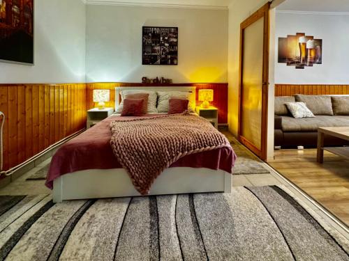 a bedroom with a bed and a couch at Kinizsi House in Szigetszentmiklós
