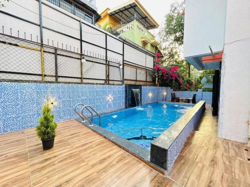 a large swimming pool on a balcony of a building at Orchid Villa - The Dream Stays ll Big Pvt Pool ll 3Ac room ll Wi-Fi ll Tv in Lonavala