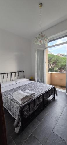 a bedroom with a large bed with a large window at Arenzano rooms in Arenzano