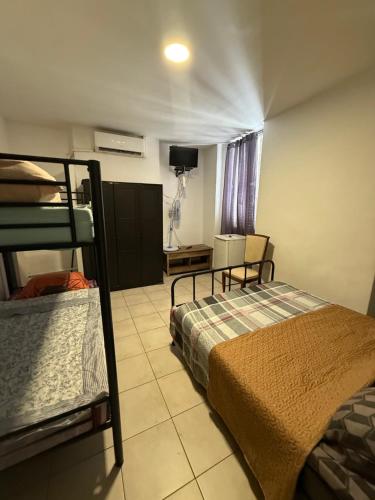 a bedroom with two bunk beds and a tv at Hotel baille castellane in Marseille