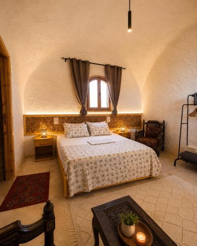 a bedroom with a bed and a window at Soléi Desert Retreat in Siwa