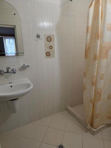 a bathroom with a sink and a shower at Комплекс ,,Трявна" in Tryavna