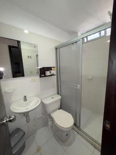 a bathroom with a toilet and a sink and a shower at Villalba Boutique Hotel in Valledupar
