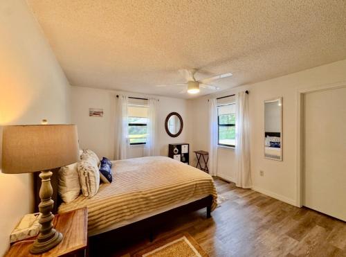 a bedroom with a bed and a ceiling fan at Pine Bluff on the Lake in Golden