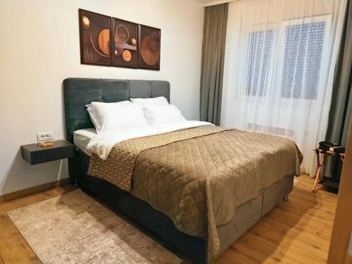 a bedroom with a bed and a window at KM Lux & SPA in Veliko Gradište