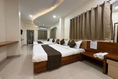 a bedroom with two beds in a room at Hotel Anantshree Inn Shree Mahakaleshwar Temple Ujjain in Ujjain