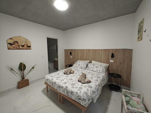 a bedroom with a bed with two stuffed animals on it at B&B Colle Degli Angeli in Penne