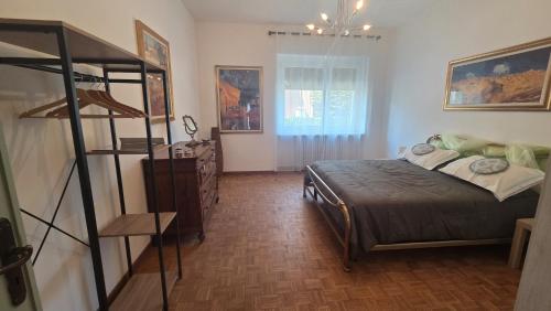 a bedroom with a bed in a room with a ladder at Green House Residence in Pinerolo