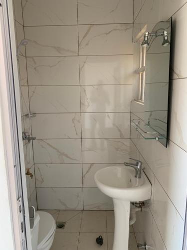 a bathroom with a sink and a toilet at pavillon « lilas » à dagué-togo in Dagé