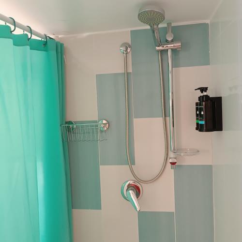 a shower in a bathroom with a green shower curtain at Casa Ninetta in Pimonte