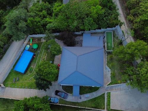 an overhead view of a house with a blue roof at Serenity Likani Villa Hotel in Borjomi