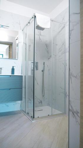 a bathroom with a shower with a glass enclosure at MESSAPIA HOME Apartments in Mesagne