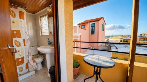 a balcony with a toilet and a table on a balcony at Diporto in Chania