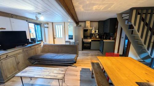 a living room with a couch and a table at La carrouere in Gujan-Mestras