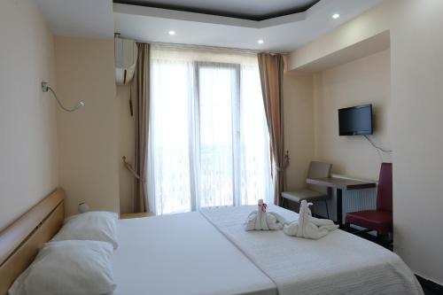 a hotel room with a bed with towels on it at KILIÇ MOTEL in Istanbul