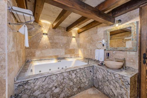 a large bathroom with a tub and a sink at Arcus Cappadocia in Göreme