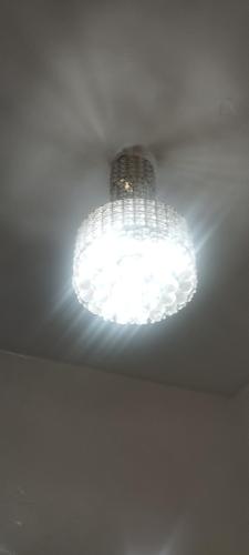 a chandelier hanging from a ceiling in a room at Mogador in Maarif