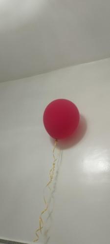 a red balloon is hanging on a wall at Mogador in Maarif
