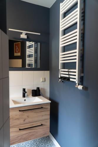 a bathroom with a sink and a mirror at "LOKAL" Apartment 2 in Bad Muskau