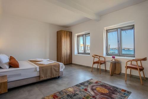 a bedroom with a bed and a table and chairs at Ondo Beach & Suites in Bodrum City