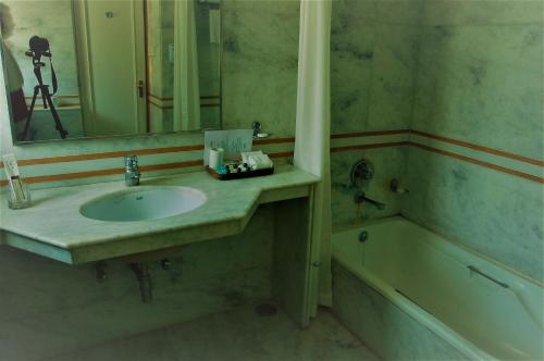 a bathroom with a sink and a bath tub at The Meadows Resort and Spa in Aurangabad