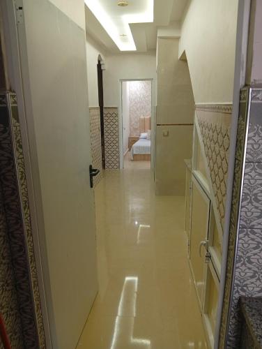 a hallway leading to a room with a bedroom at BENYOUNECh in Belyounech 