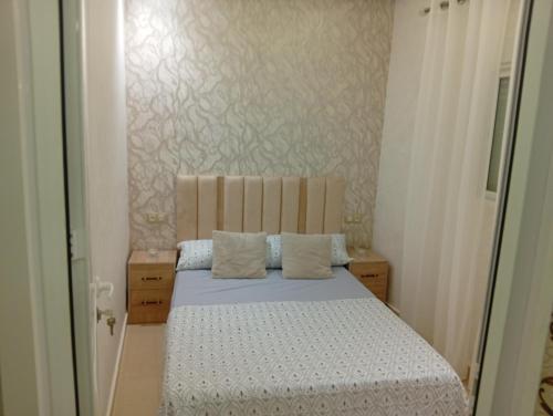 a small bedroom with a bed in a room at BENYOUNECh in Belyounech 