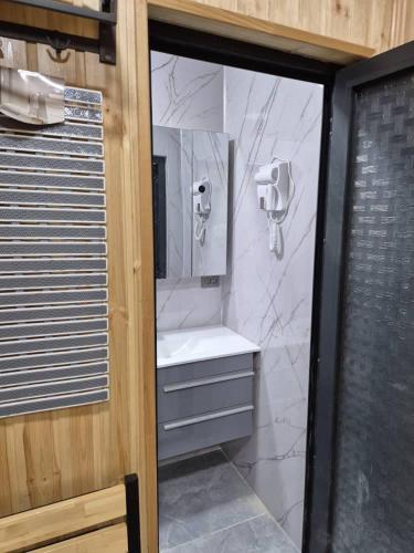 a bathroom with a sink and a shower at Villa by HomeLand in Khujand