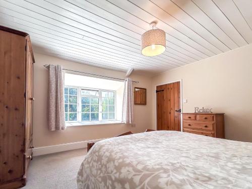 a bedroom with a large bed and a window at 6 Bed in Filey oc-94524 in Reighton