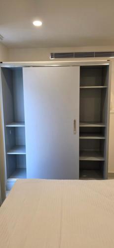 an empty closet with a white door and shelves at Lucy Residences in Ernakulam