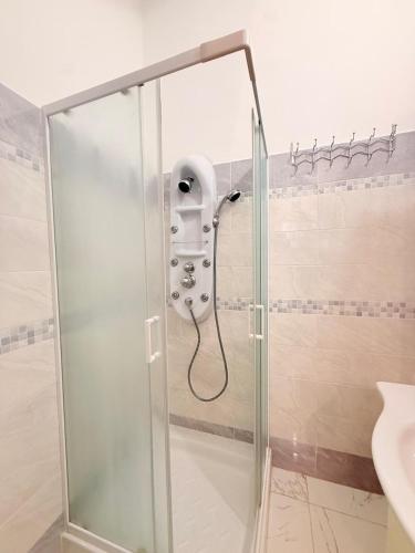 a shower with a glass door in a bathroom at Via Acquedotto 54 in Olbia