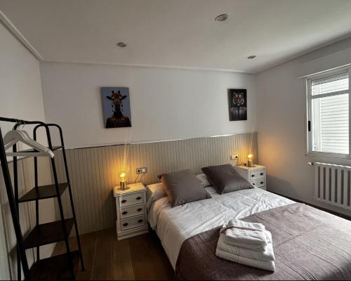 a bedroom with a bed and two night stands at Casa Pepe in Ourense