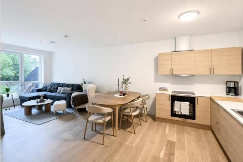 a kitchen and living room with a table and a couch at The Haven II - Cozy 2BR Voss - The Voss Collection in Vossevangen