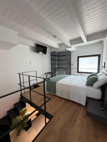 a bedroom with a large bed and a staircase at Tradomari in Mesagne