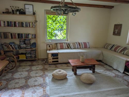 a living room with a couch and a table at Czerpak in Małszewko