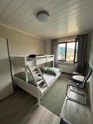 a bedroom with two bunk beds and a window at Haus am Skywalk 3L in Beverungen