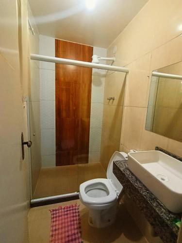 a bathroom with a shower and a toilet and a sink at Mata Virgem Hostel e Pousada in Abraão