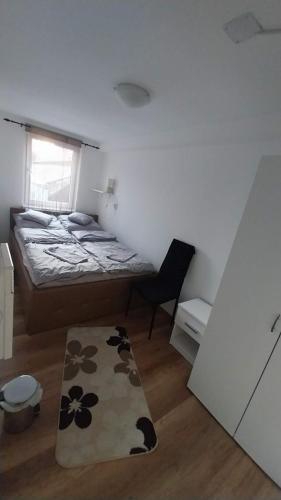 a bedroom with a bed and a rug on the floor at Zitanka Apartman Bogács in Bogács