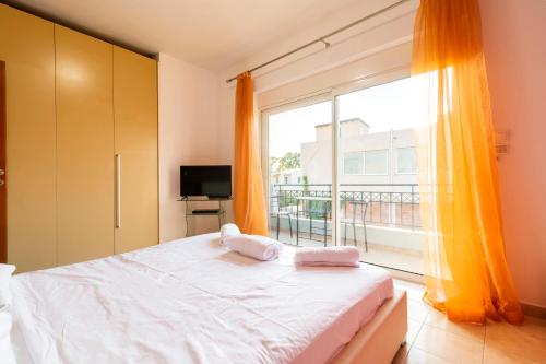 a bedroom with a bed and a large window at Dolphins maisonette Rhodes in Ialysos