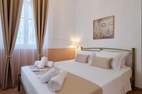 two beds in a room with towels on them at Aphrodite luxury rooms in Mytilene